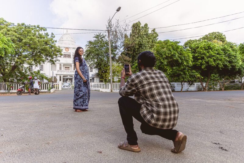 Kobe and Ramya posing in front of the iconic white Jaffna Library, blending elegance and heritage. Wedding portraits captured by Banu Photography.