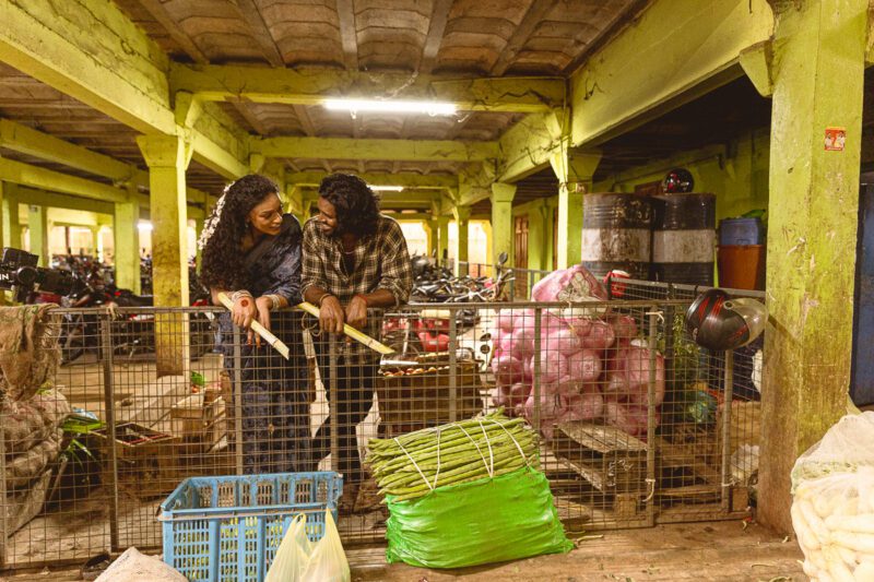 Candid shots of Kobe and Ramya exploring Tirunelveli Market, surrounded by local colors and culture. A playful moment from their Jaffna wedding story captured by Banu Photography.