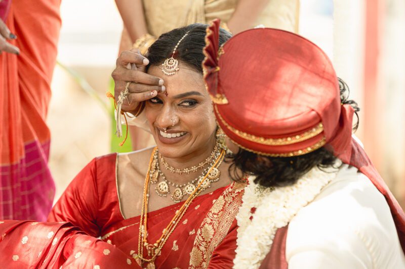 Kobe and Ramya exchanging vows at their native temple in Jaffna, surrounded by close family and friends. Traditional Tamil wedding captured by Banu Photography. Decor by Rohins Events, makeup by Vinthusha.