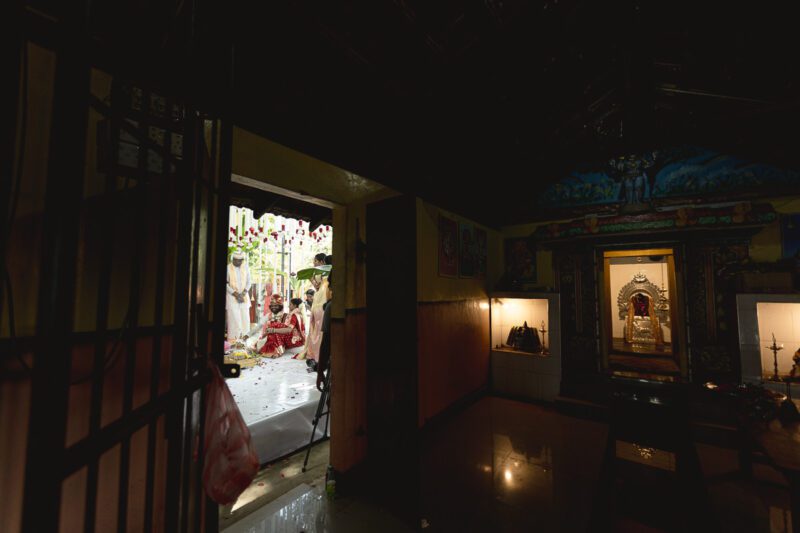Kobe and Ramya exchanging vows at their native temple in Jaffna, surrounded by close family and friends. Traditional Tamil wedding captured by Banu Photography. Decor by Rohins Events, makeup by Vinthusha.